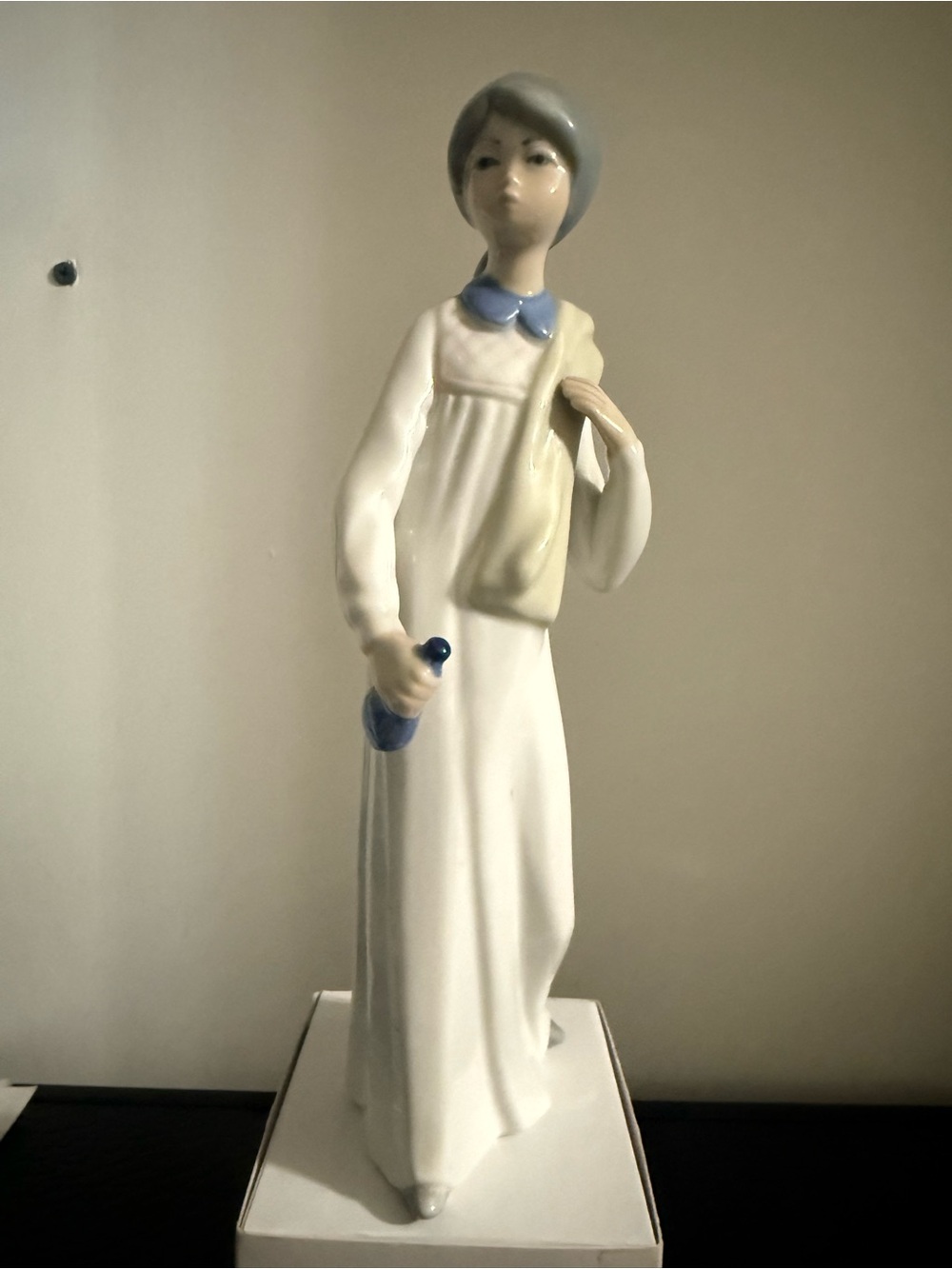 Porcelain Figurine Girl in White and Blue Casades name under.